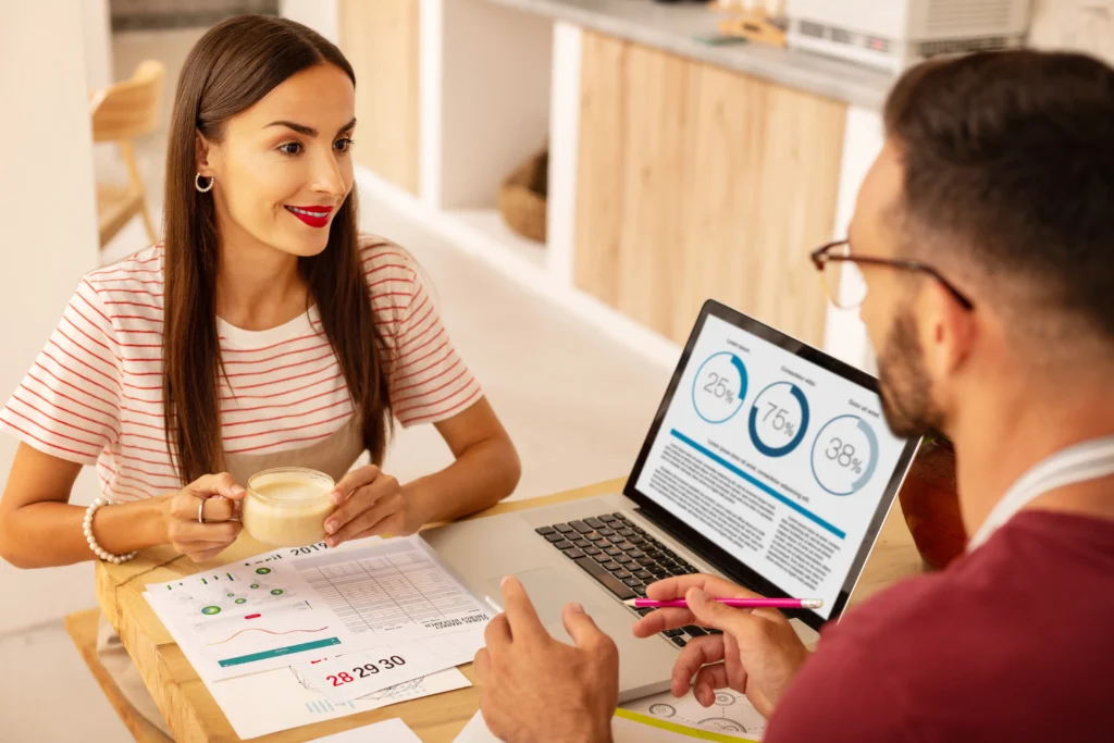 Woman explaining to a man that credit monitoring has prevented identity theft